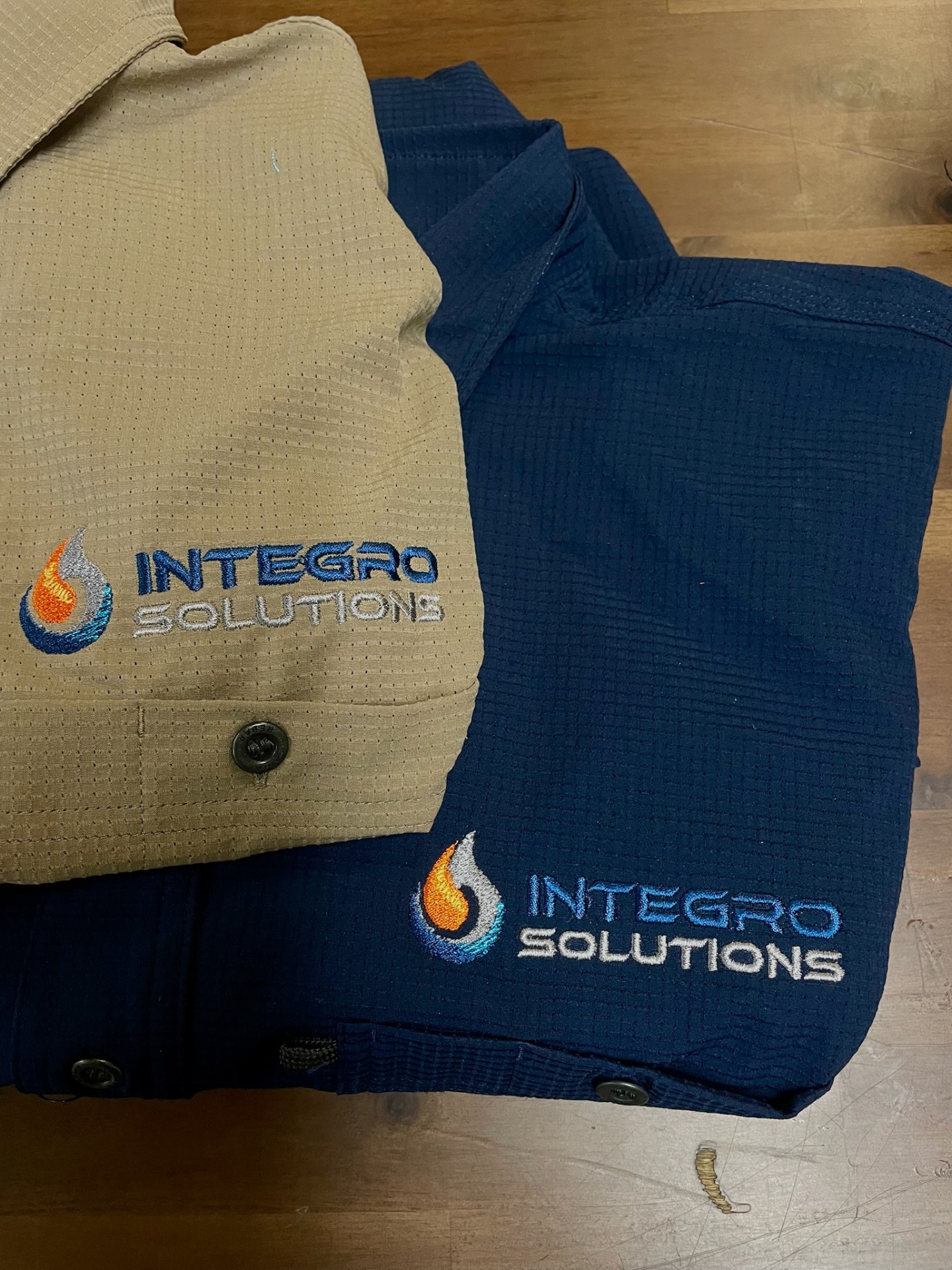 Integro Solutions custom embroidered work shirts in tan and navy