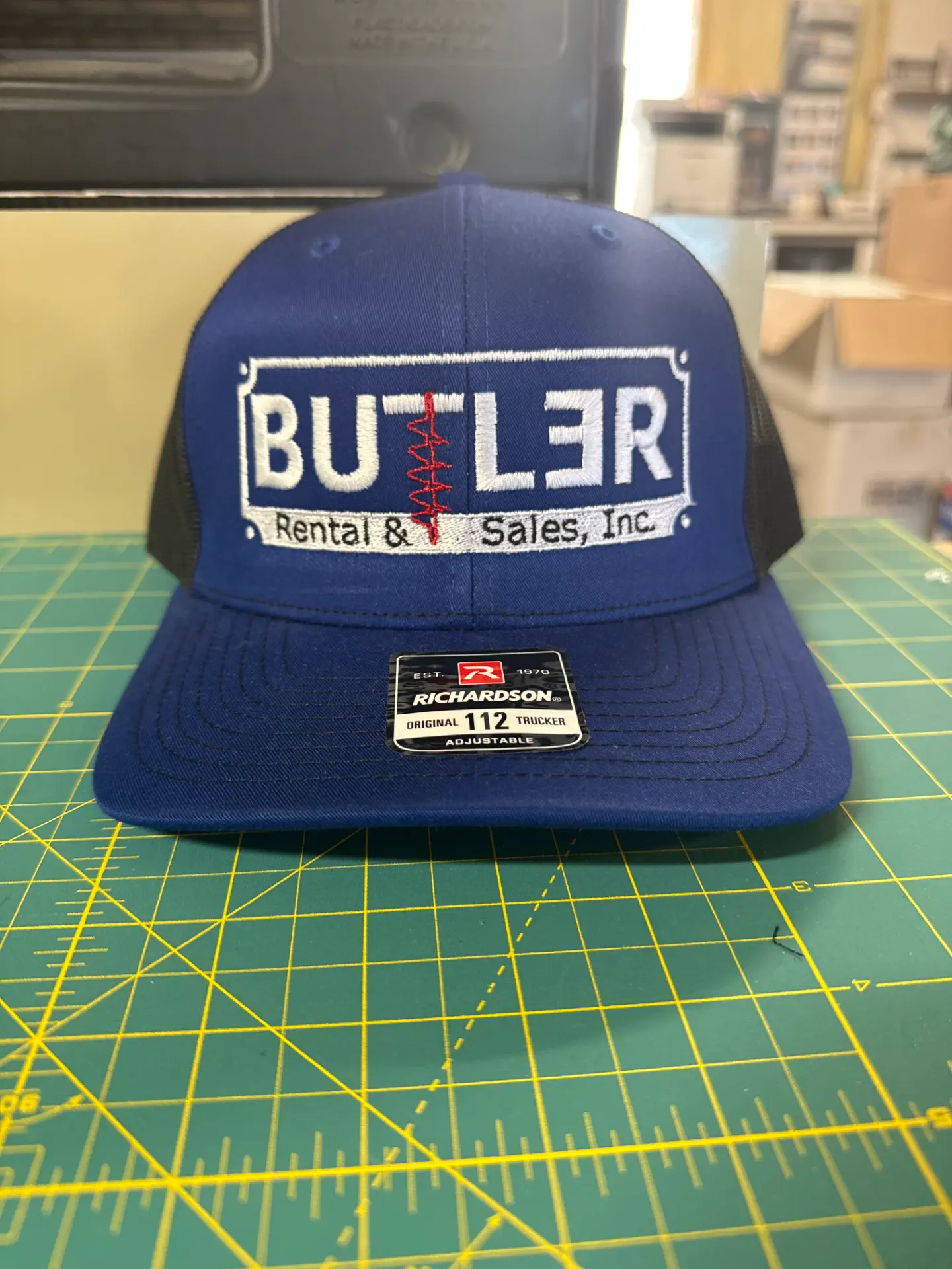 Royal blue Richardson 112 trucker hat with embroidered Butler Rental & Sales, Inc. logo